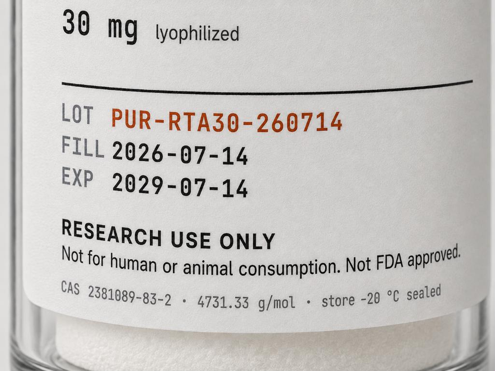 Close-up of the printed label on a curved glass vial, reading RETATRUTIDE, 30 mg lyophilized, and below a rule, LOT PUR-RTA30-260714 in copper with FILL 2026-07-14 and EXP 2029-07-14 in dark monospace, above the line RESEARCH USE ONLY.