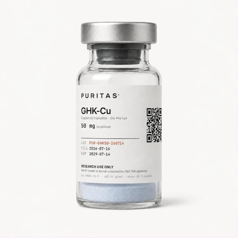 Puritas GHK-Cu 50 mg vial containing a pale blue lyophilized cake, label showing lot PUR-GHK50-260714 and a QR code