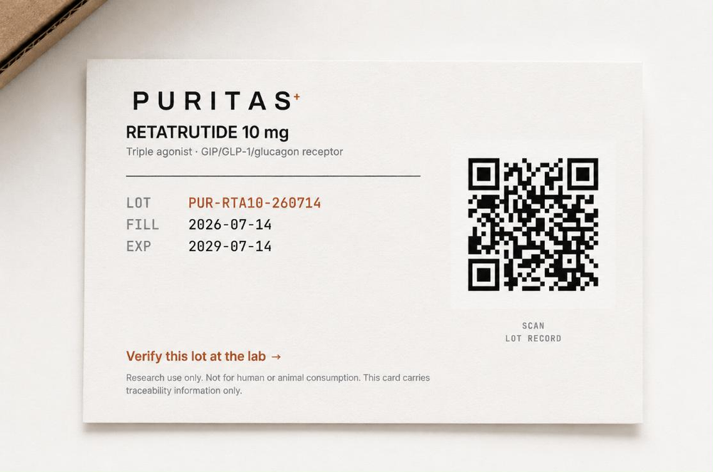 The lot card photographed beside the corner of a kraft carton. It reads RETATRUTIDE 10 mg, Triple agonist GIP/GLP-1/glucagon receptor, then LOT PUR-RTA10-260714 in copper, FILL 2026-07-14 and EXP 2029-07-14. A QR code labelled SCAN LOT RECORD sits to the right, above a copper link reading Verify this lot at the lab.