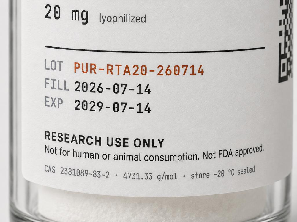Close-up of the printed label on a curved glass vial, reading RETATRUTIDE, 20 mg lyophilized, and below a rule, LOT PUR-RTA20-260714 in copper with FILL 2026-07-14 and EXP 2029-07-14 in dark monospace, above the line RESEARCH USE ONLY.